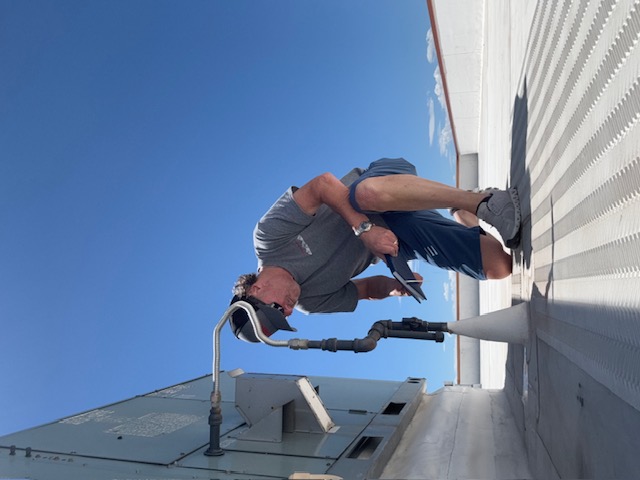 4 Peaks technician inspecting a rooftop unit and the surrounding membrane
